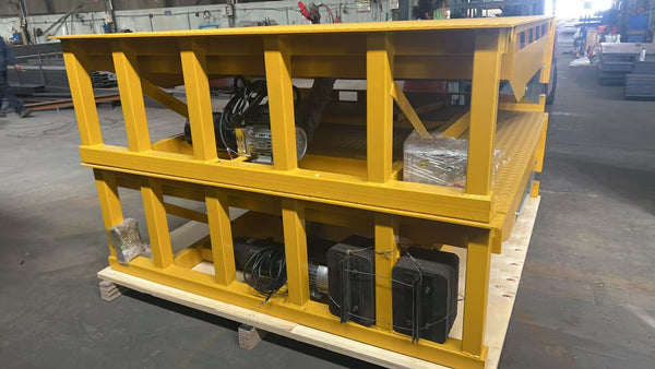 10-ton fixed dock leveler with yellow steel frame and hydraulic unit on wooden pallet ready for shipment
