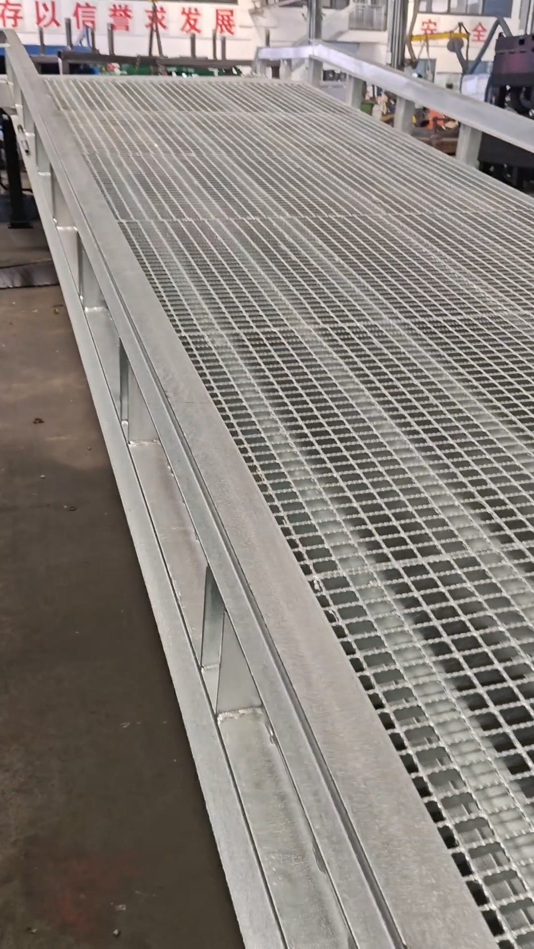 Mobile dock ramp with galvanized steel grating platform in outdoor loading environment