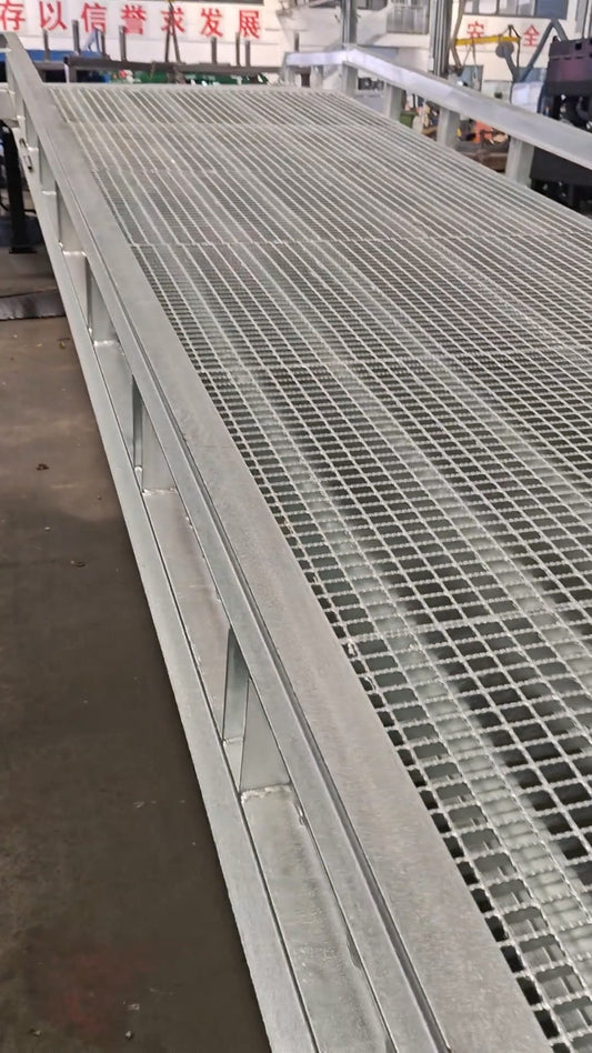 Mobile dock ramp with galvanized steel grating platform in outdoor loading environment