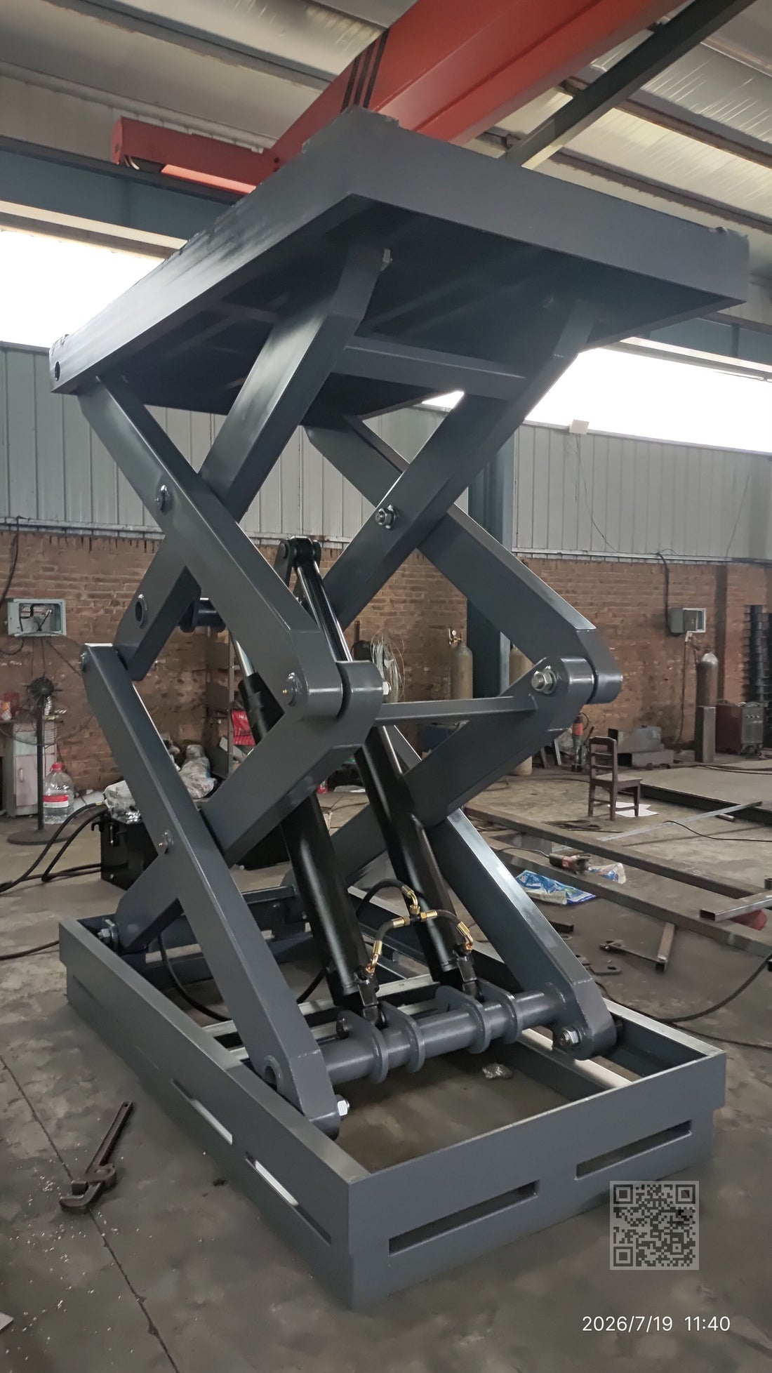 BEACON Industries 5-ton fixed scissor lift with dual hydraulic cylinders on industrial floor