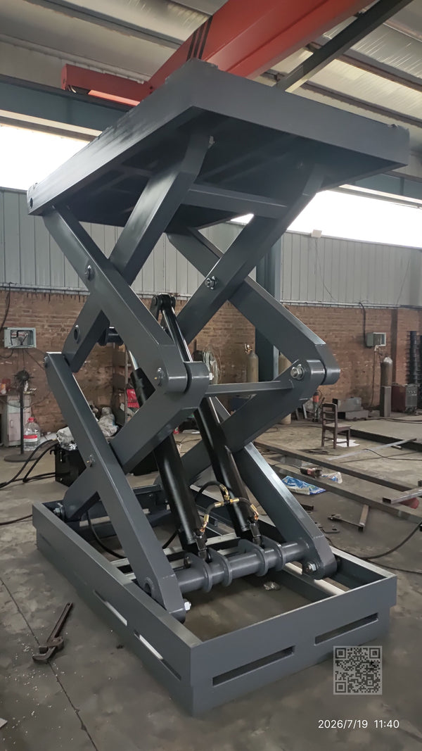 BEACON Industries 5-ton fixed scissor lift with dual hydraulic cylinders on industrial floor